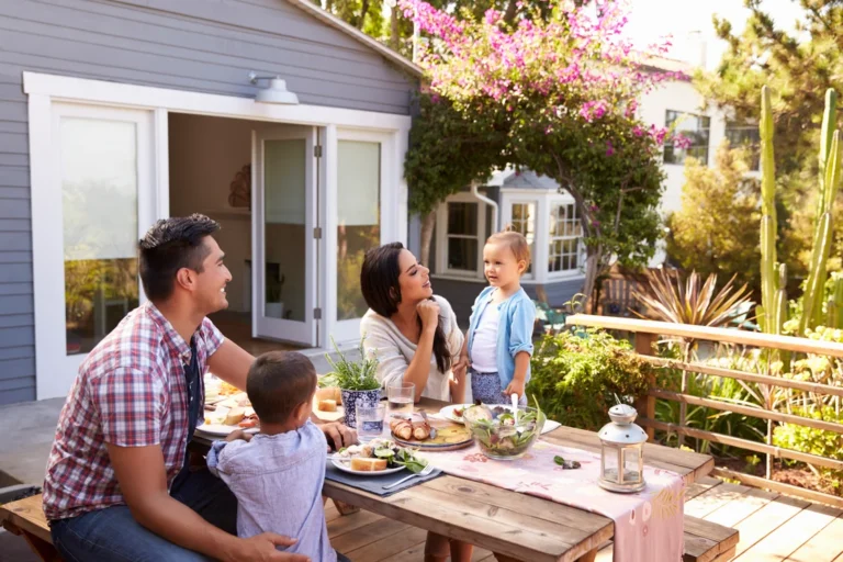 family-at-home-eating-outdoor-meal-in-garden-together