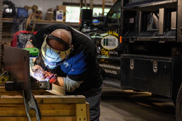 bahler brothers team welding in garage