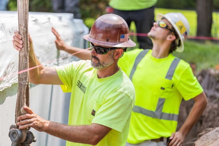 Bahler Brothers crew installing a Soake Pool in West Hartford, Connecticut, aligning pool walls and leveling the foundation