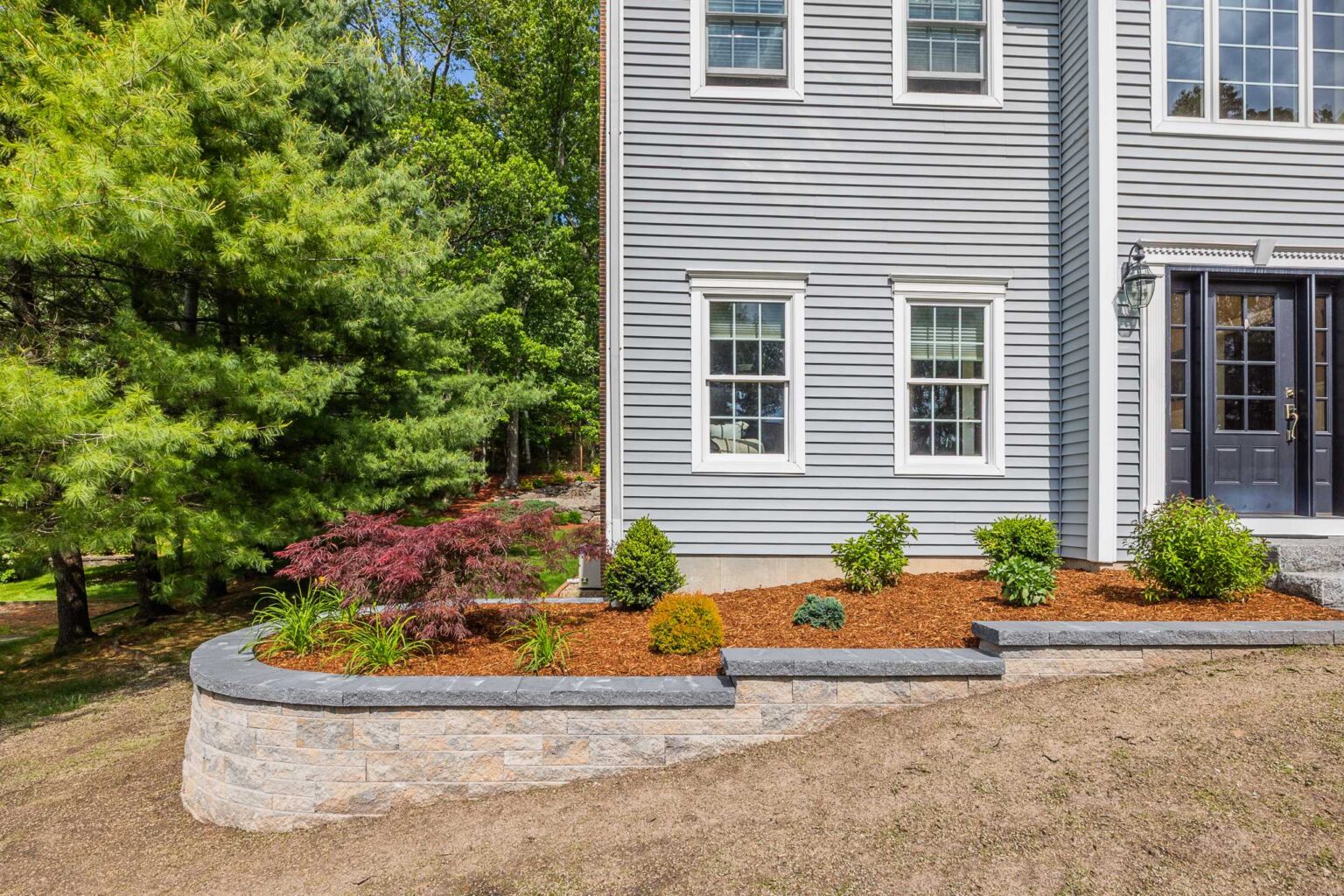 New retaining wall with landscape design built by Bahler Brothers in Manchester, Connecticut