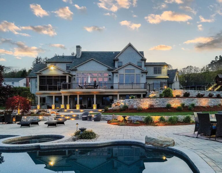 Landscape lighting with gunnite pool, retaining wall, landscape design, paver patio built by Bahler Brothers in Longmeadow, Massachusetts