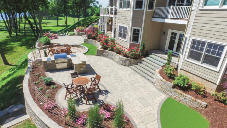 Custom patio design with artificial turf and retaining wall arial photograph