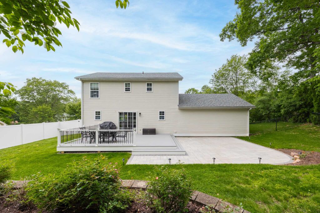 Custom raised deck and paver patio in backyard built by Bahler Brothers in Ellington, Connecticut
