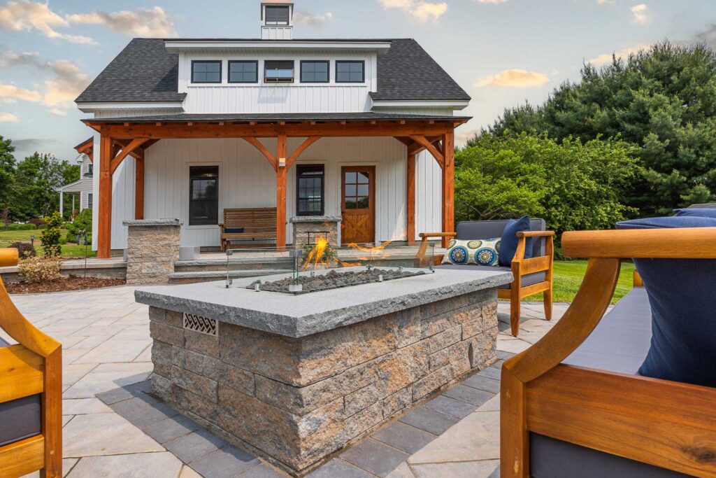 Custom gas fire pit with paver patio, sitting wall, pillars, steps built by Bahler Brothers in Ellington, Connecticut