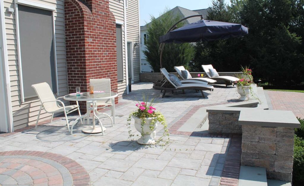 Custom raised paver patio with sitting walls and pillars built by Bahler Brothers