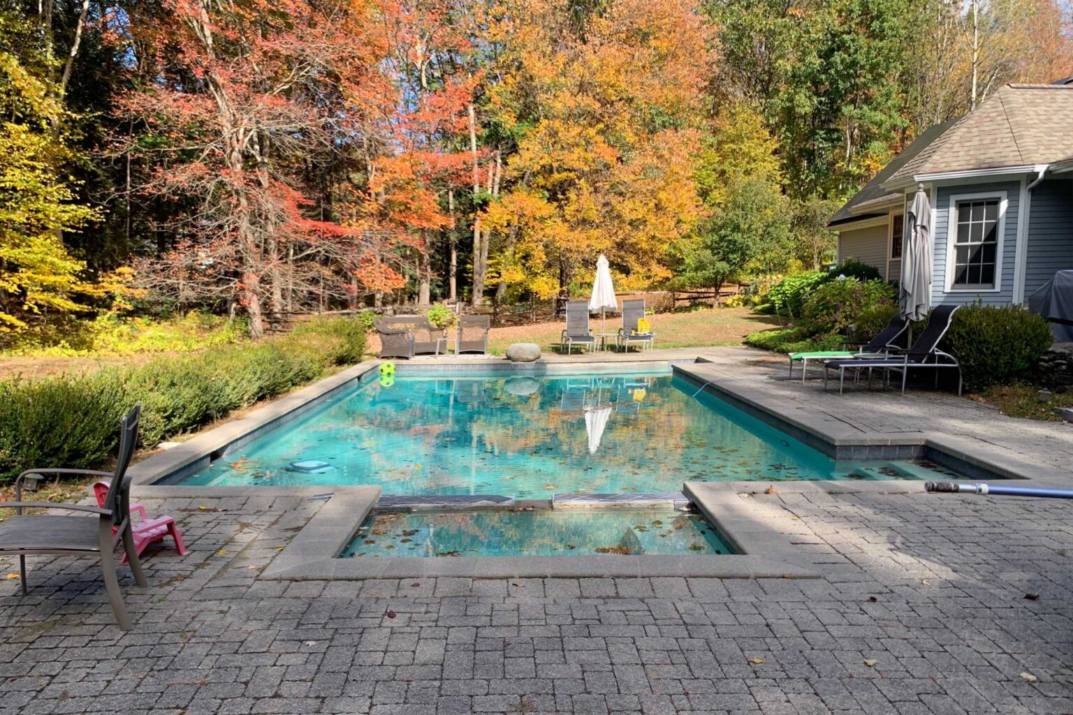 Before project for custom patio around swimming pool in Easthampton, Massachusetts