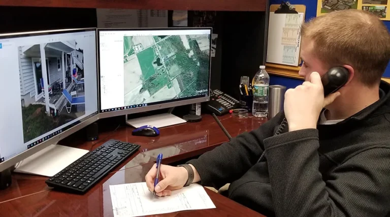 Bahler Brothers designer discussing project plans over the phone and taking notes