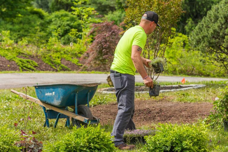 landscape design and management crew at Bahler Brothers digging a residential garden