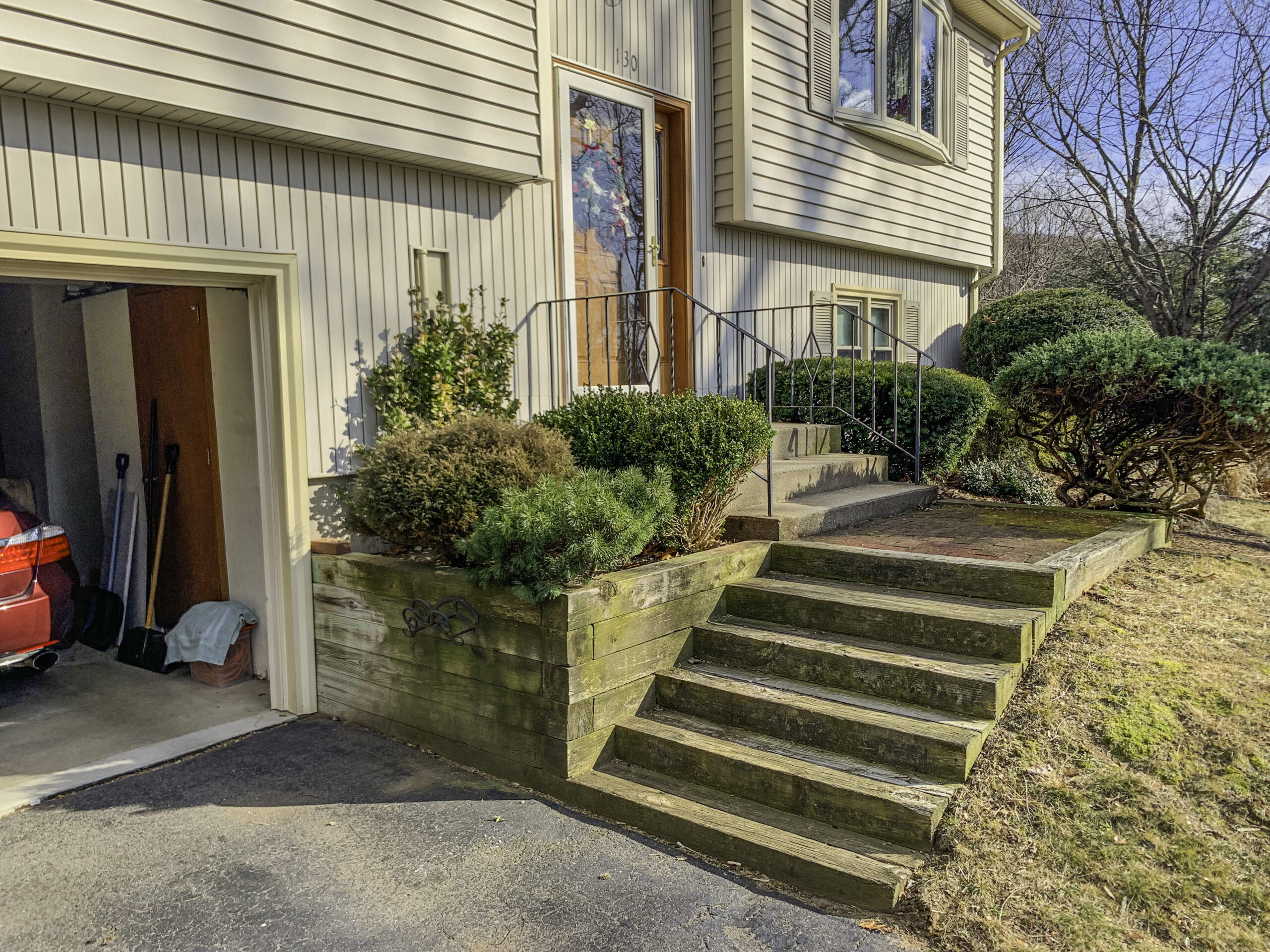 Old wood steps attached to driveway leading up to front entrance